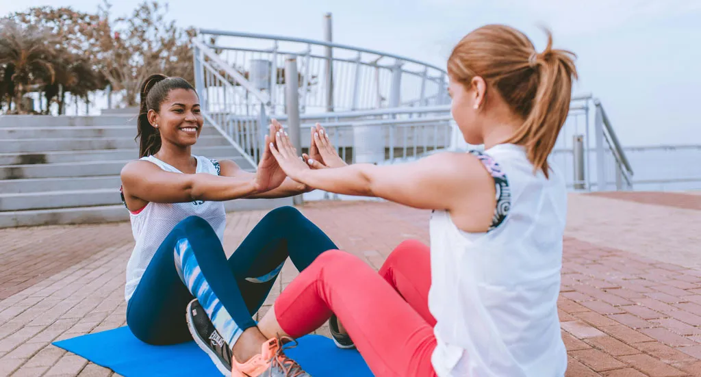 Fueling recovery. Two women doing excersize together