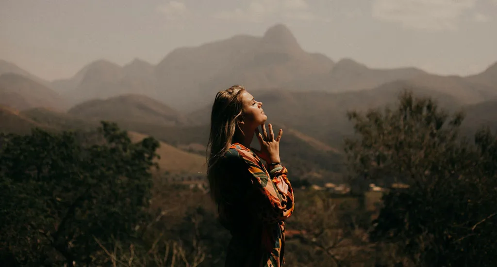 Lady standing in field feeling blessed because of hope in recovery