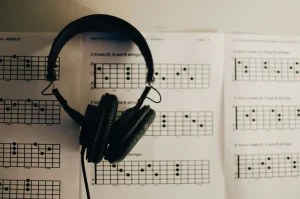 The healing role of music - earphones placed on sheet music