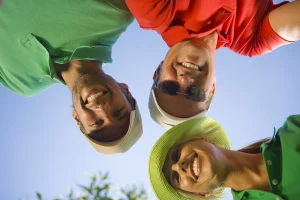 Three people smiling and celebrating recovery