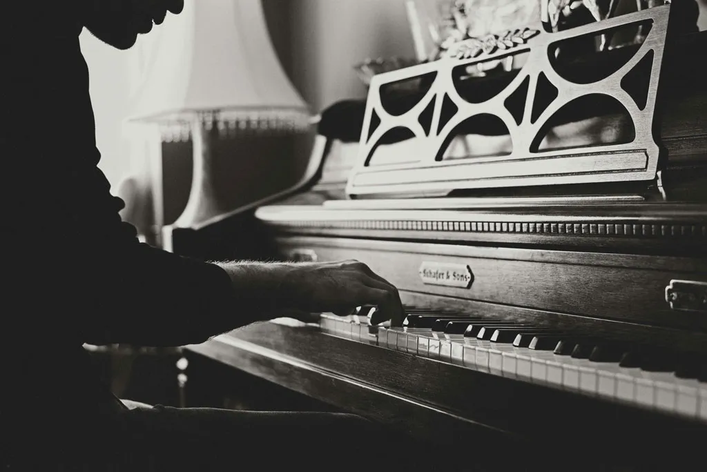 The healing role of music in recovery Emotional healing through music - a  black and white photo of someone playing piano